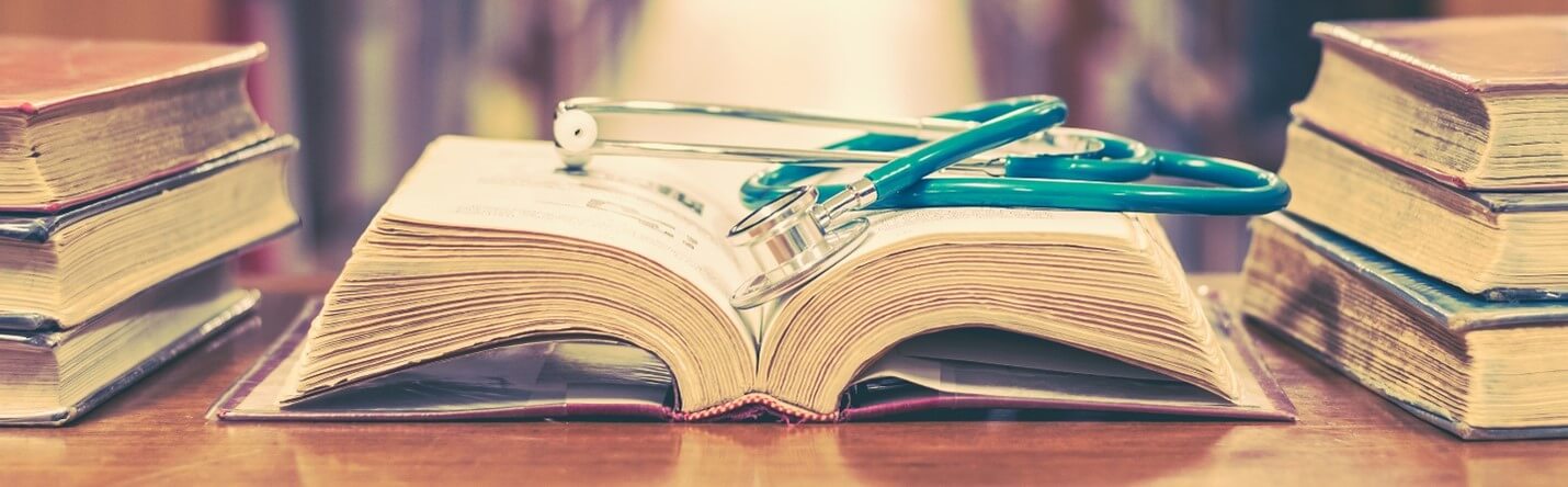 Stethescope sitting on open book